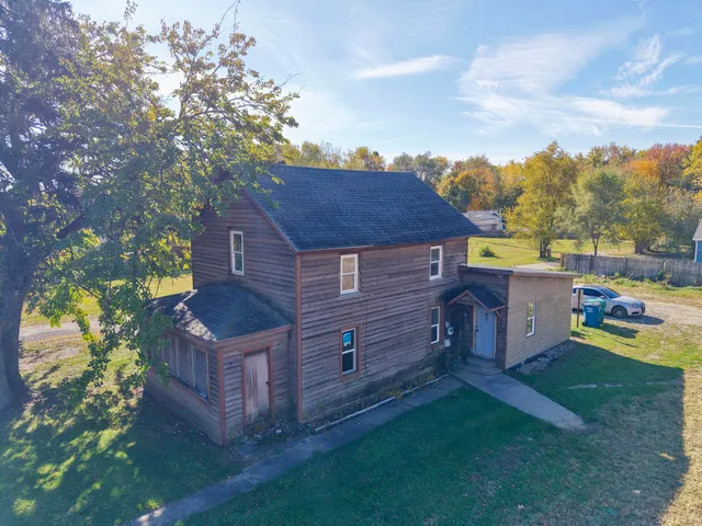 a view of a house with a yard and wooden fence