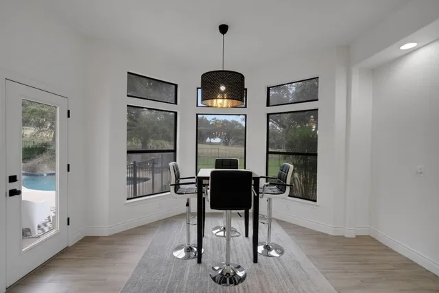 a view of a dining room with furniture and chandelier