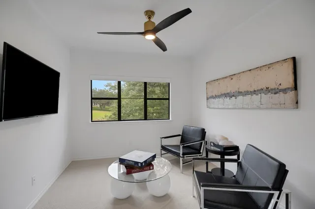 a bedroom with a bed window and flat screen tv