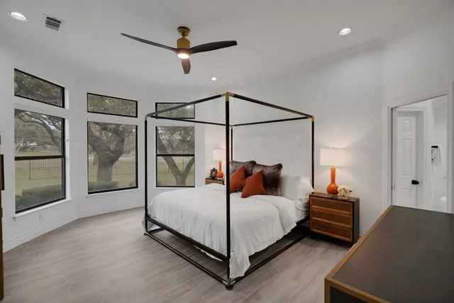 a bedroom with a large bed and a window