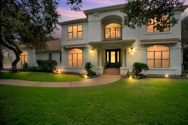 a large white kitchen with lots of counter space dining table and chairs
