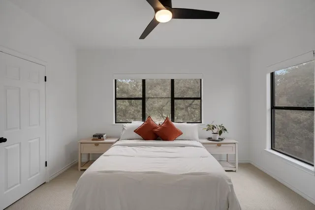 a bathroom with a glass door shower a mirror and a sink