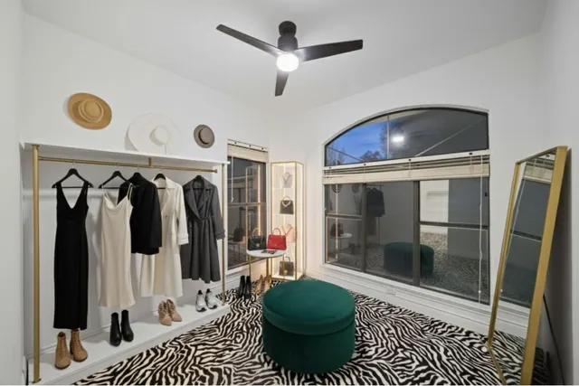 a view of empty room with ceiling fan