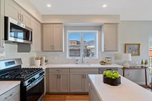 a bathroom with a granite countertop sink and a white cabinets