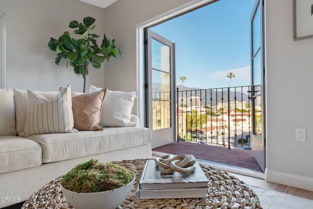 a living room with fireplace furniture and a potted plant