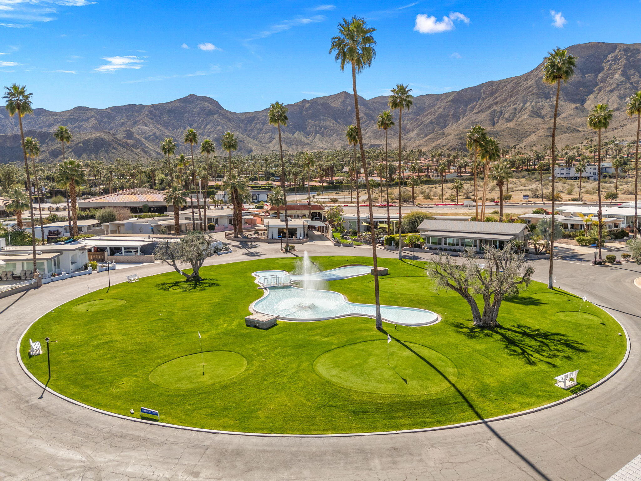 70260 Highway 111, Unit 57 Rancho Mirage, CA 92270 - Photo 1 of 38 a view of a swimming pool with a table and chairs