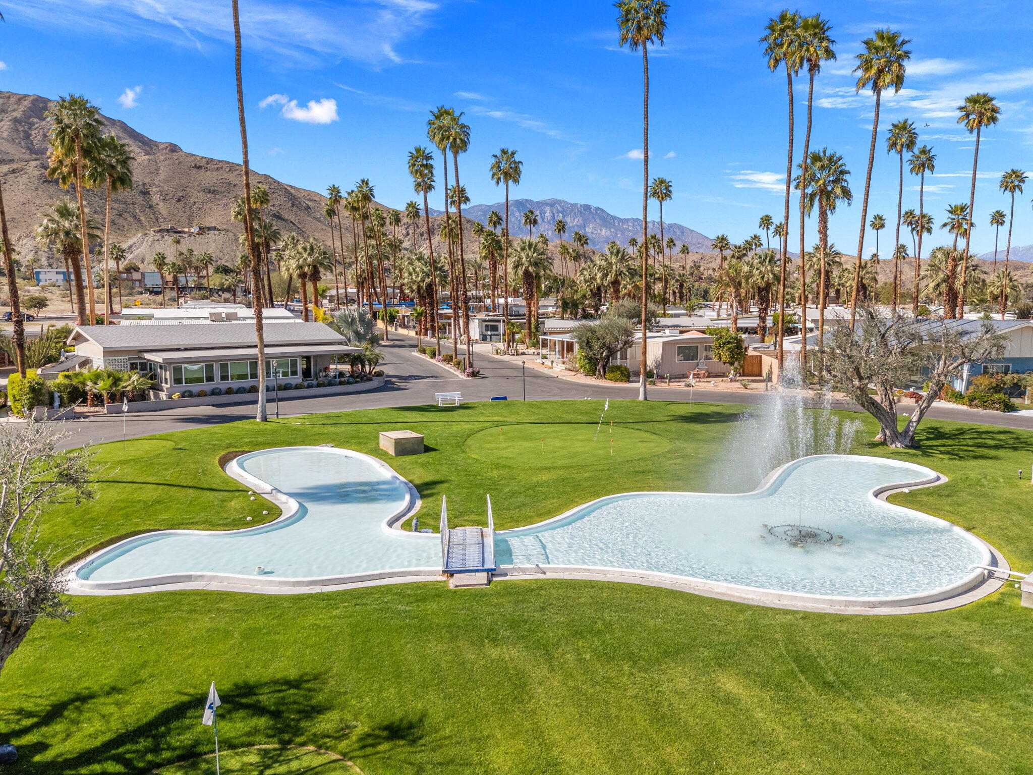 70260 Highway 111, Unit 57 Rancho Mirage, CA 92270 - Photo 2 of 38 a view of a swimming pool with a yard