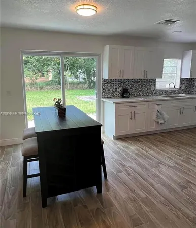 a kitchen with a table chairs and a window