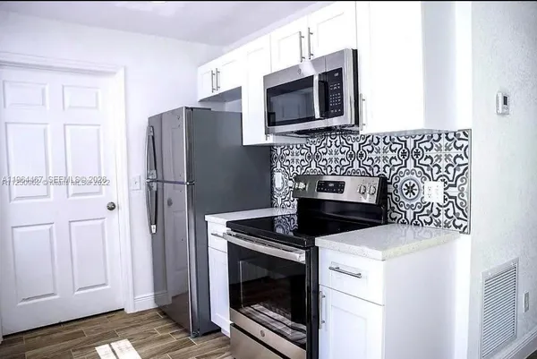 a kitchen with a stove microwave and refrigerator