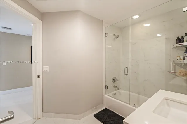 a bathroom with a bathtub shower and toilet