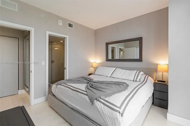 a bedroom with a bed and painting on the wall