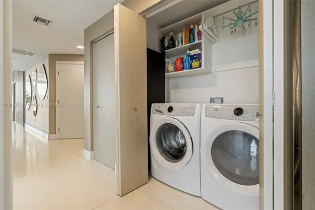 a view of a hallway with washer and dryer