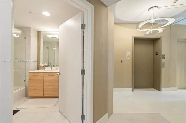 a bathroom with a double vanity sink a mirror and a shower