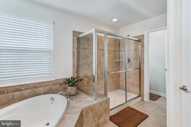 a bathroom with a tub shower and sink