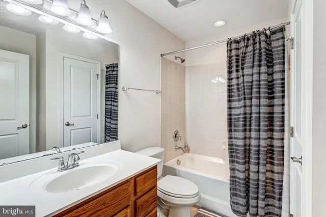 a bathroom with a sink a toilet a shower and a mirror