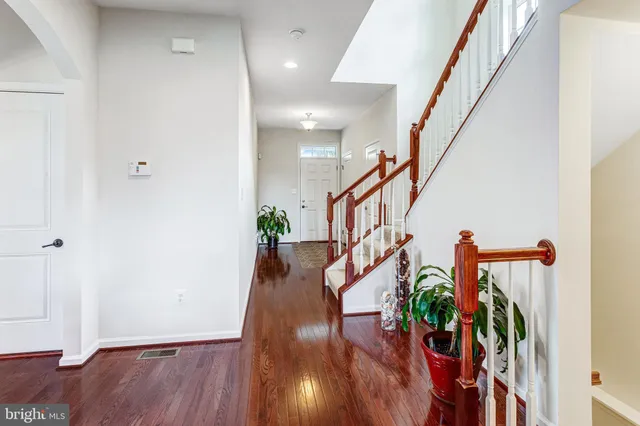 a view of entryway and hall with wooden floor