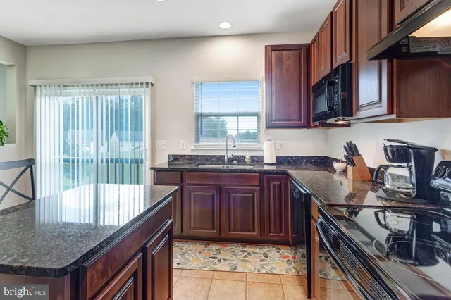 a kitchen with a stove a sink and a cabinets