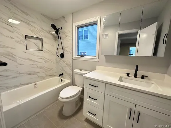 a bathroom with a sink a toilet and a bathtub