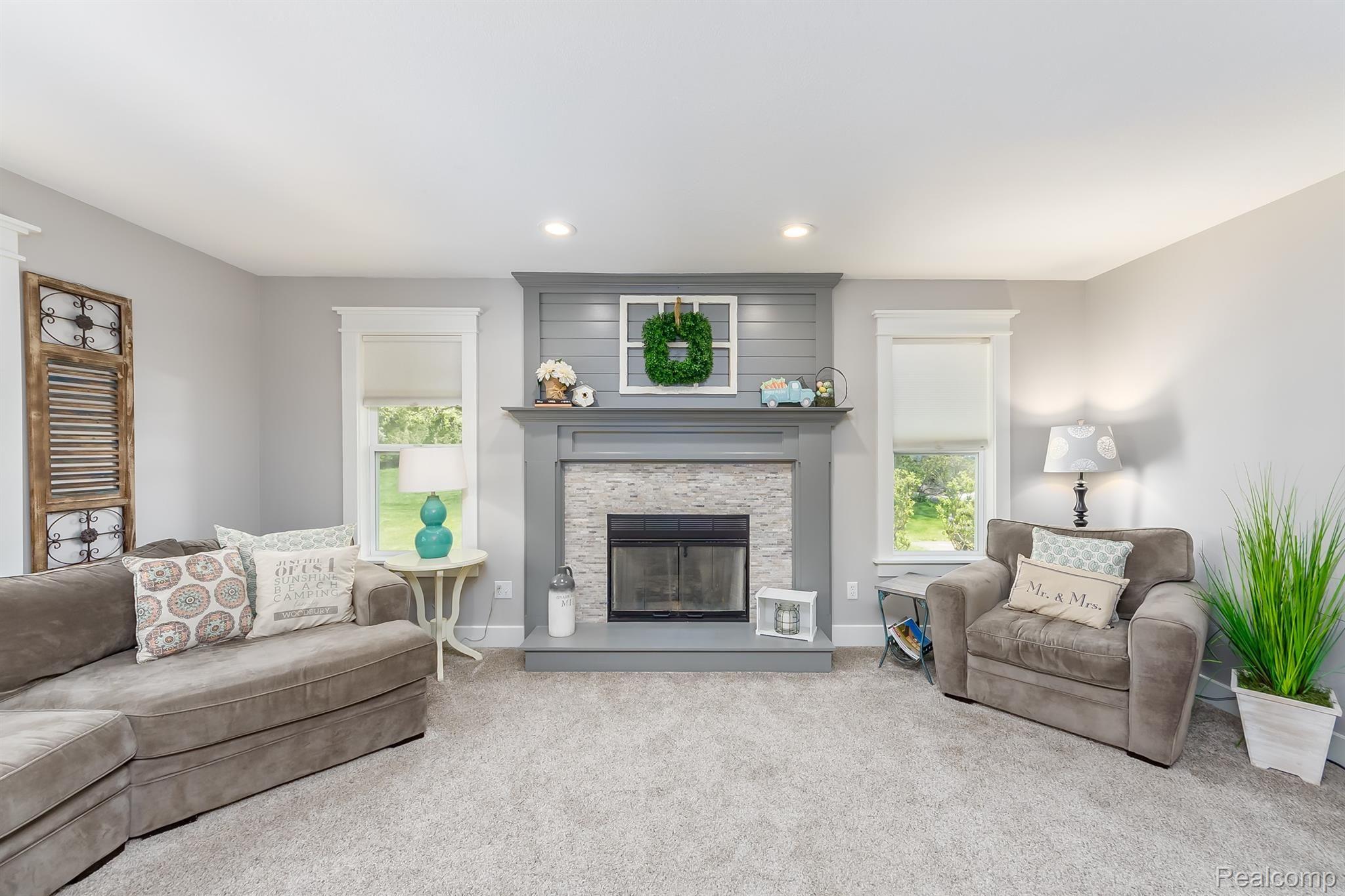 9855 Viewcrest Court Howell, MI 48843 - Photo 7 of 30 Gas fireplace with tile surround and shiplap above the mantel