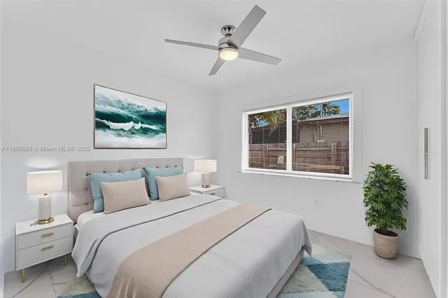 an empty room with a window and a ceiling fan