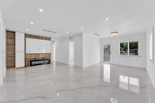 a view of kitchen with stainless steel appliances a refrigerator and a stove top oven