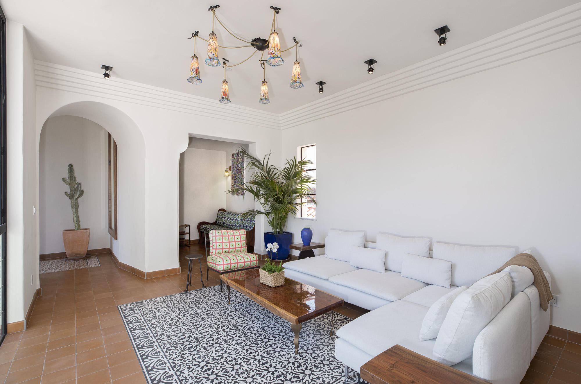 819 Garden Street Santa Barbara, CA 93101 - Photo 23 of 41 a living room with furniture and a chandelier