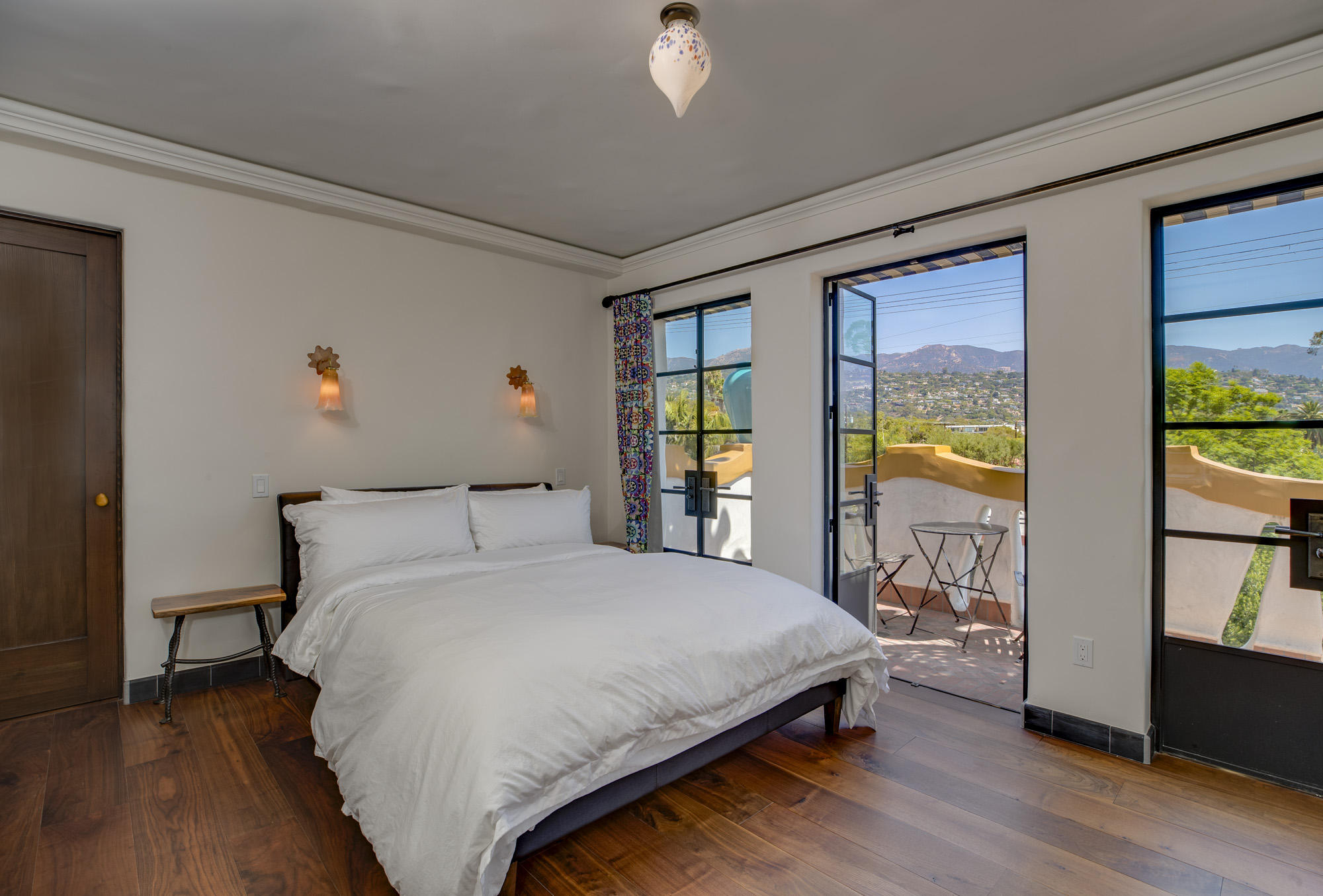 819 Garden Street Santa Barbara, CA 93101 - Photo 5 of 41 a bedroom with a large bed and a large window