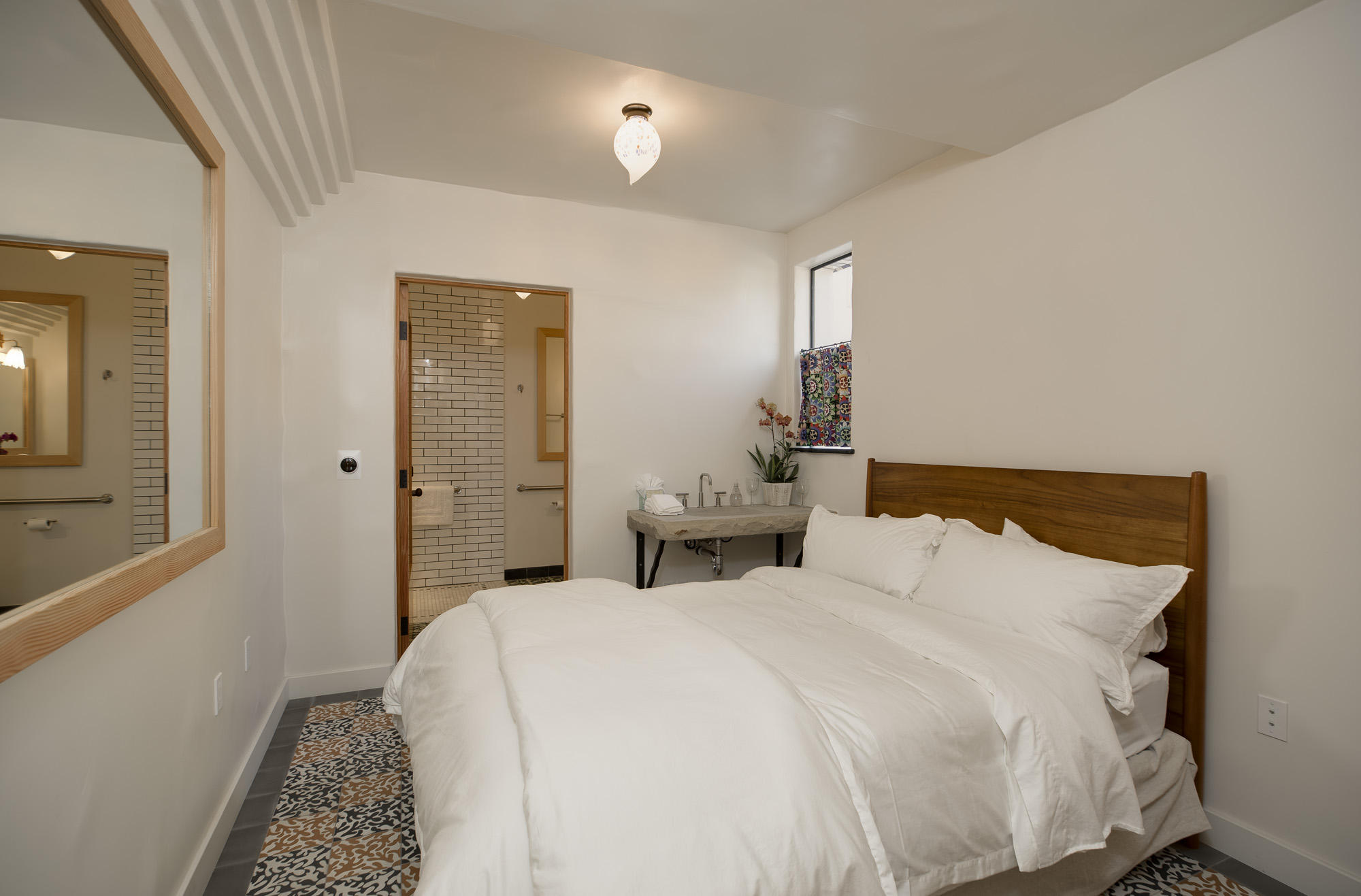 819 Garden Street Santa Barbara, CA 93101 - Photo 10 of 41 a bedroom with a bed and a mirror