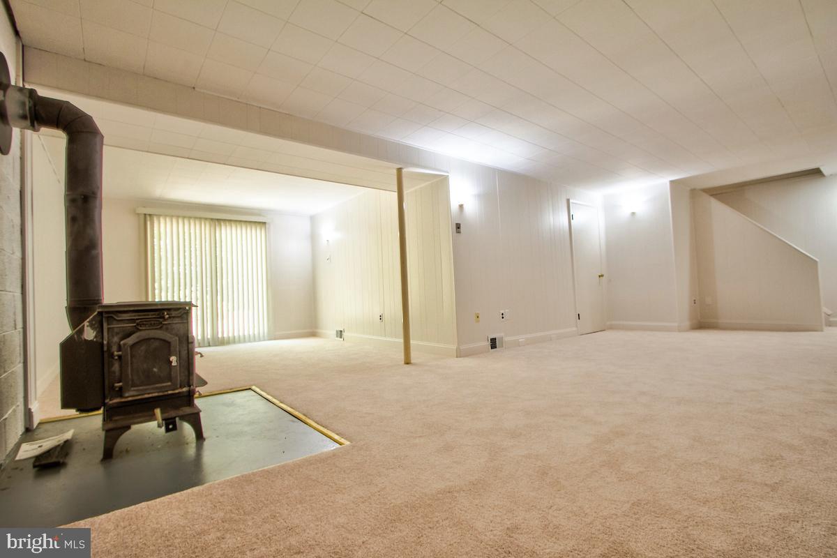 7102 Hadlow Court Springfield, VA 22152 - Photo 21 of 38 Wood burning Stove in Rec Room