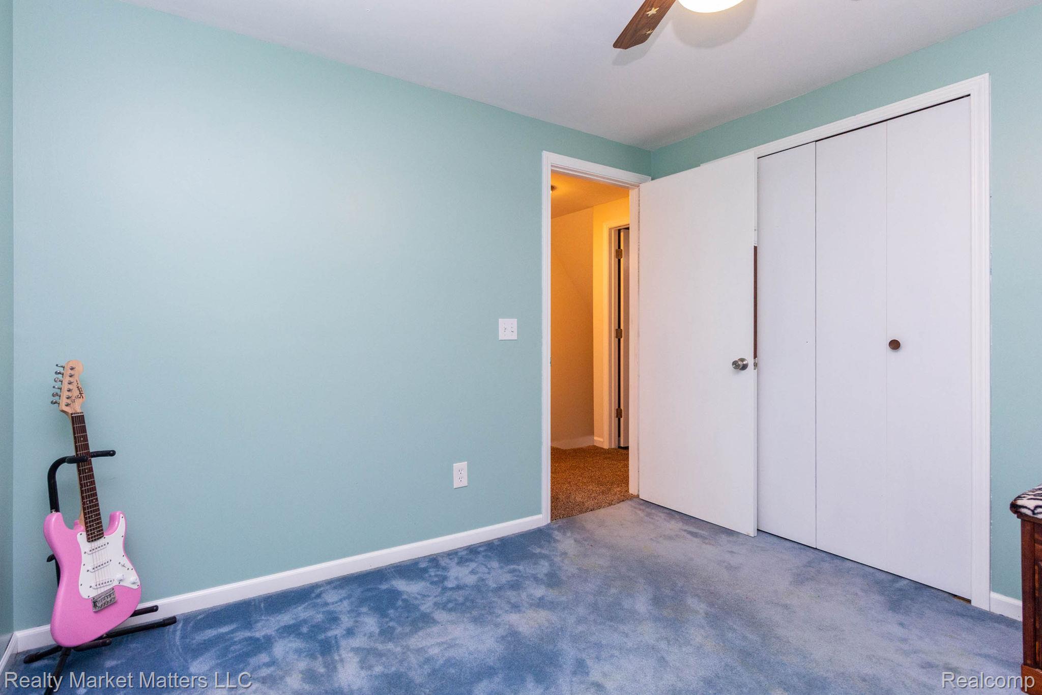 770 North Fairgrounds Road Imlay City, MI 48444 - Photo 21 of 55 Recessed entry with a solid core door, bi-fold closet doors, and a ceiling fan