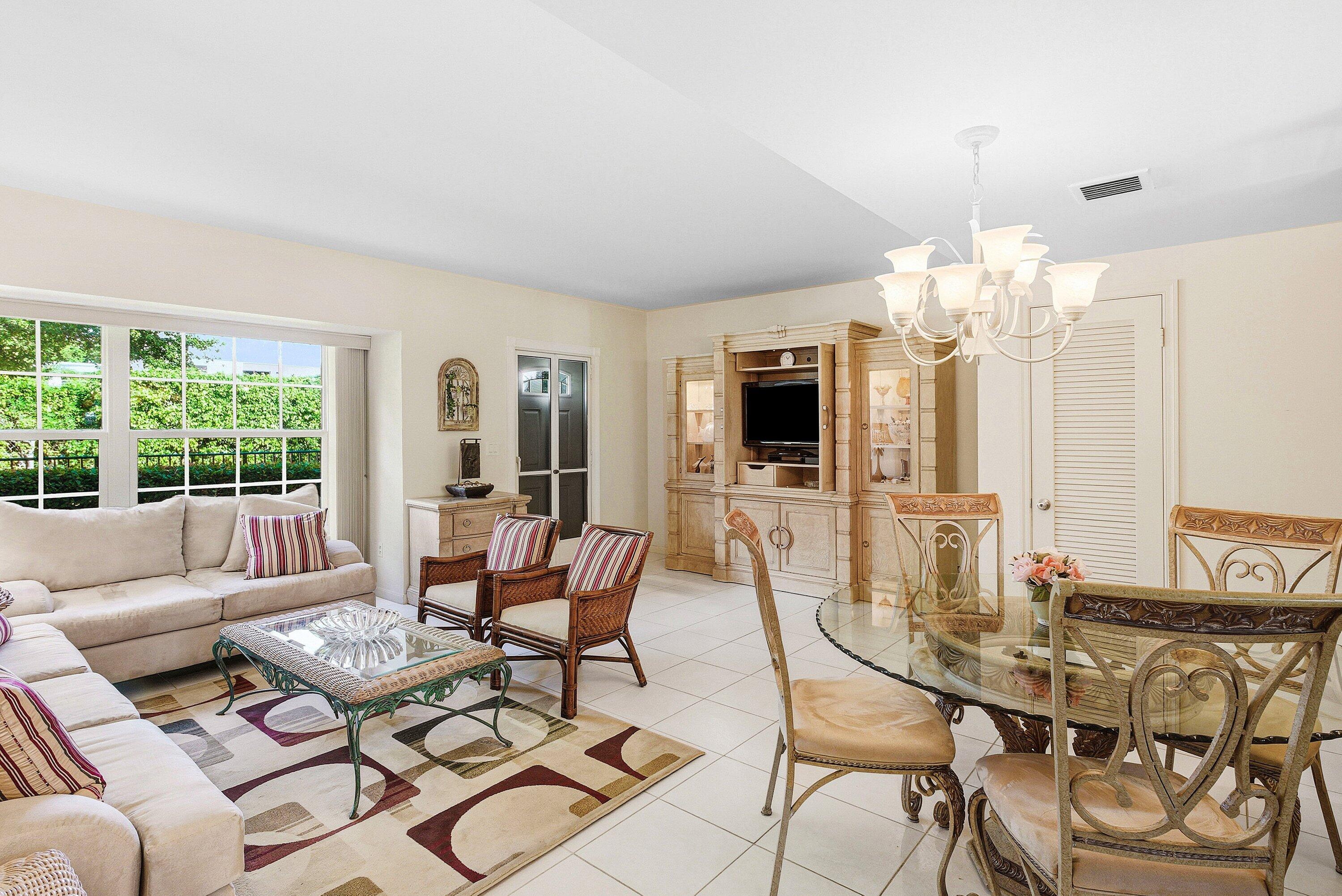 6590 North Ocean Boulevard, Unit 5 Ocean Ridge, FL 33435 - Photo 5 of 20 a living room with furniture a flat screen tv and a large window