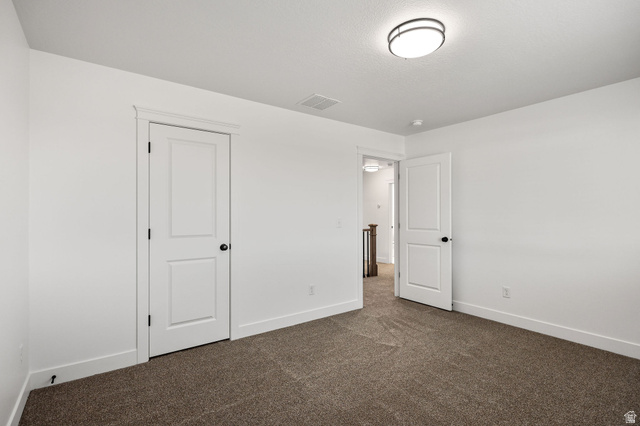 1661 West Ross Road Syracuse, UT 84075 - Photo 21 of 28 Unfurnished bedroom featuring baseboards and dark colored carpet