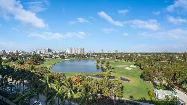 an aerial view of a house with a swimming pool yard and lake view in back