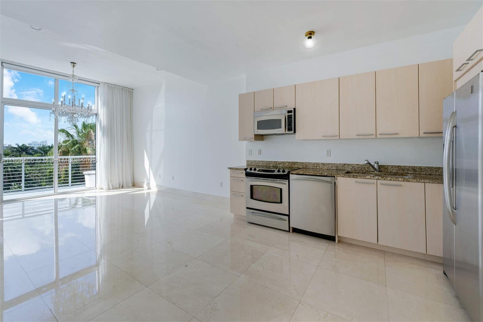 2001 Meridian Avenue, Unit 516 Miami Beach, FL 33139 - Photo 2 of 26 a kitchen with white cabinets and appliances