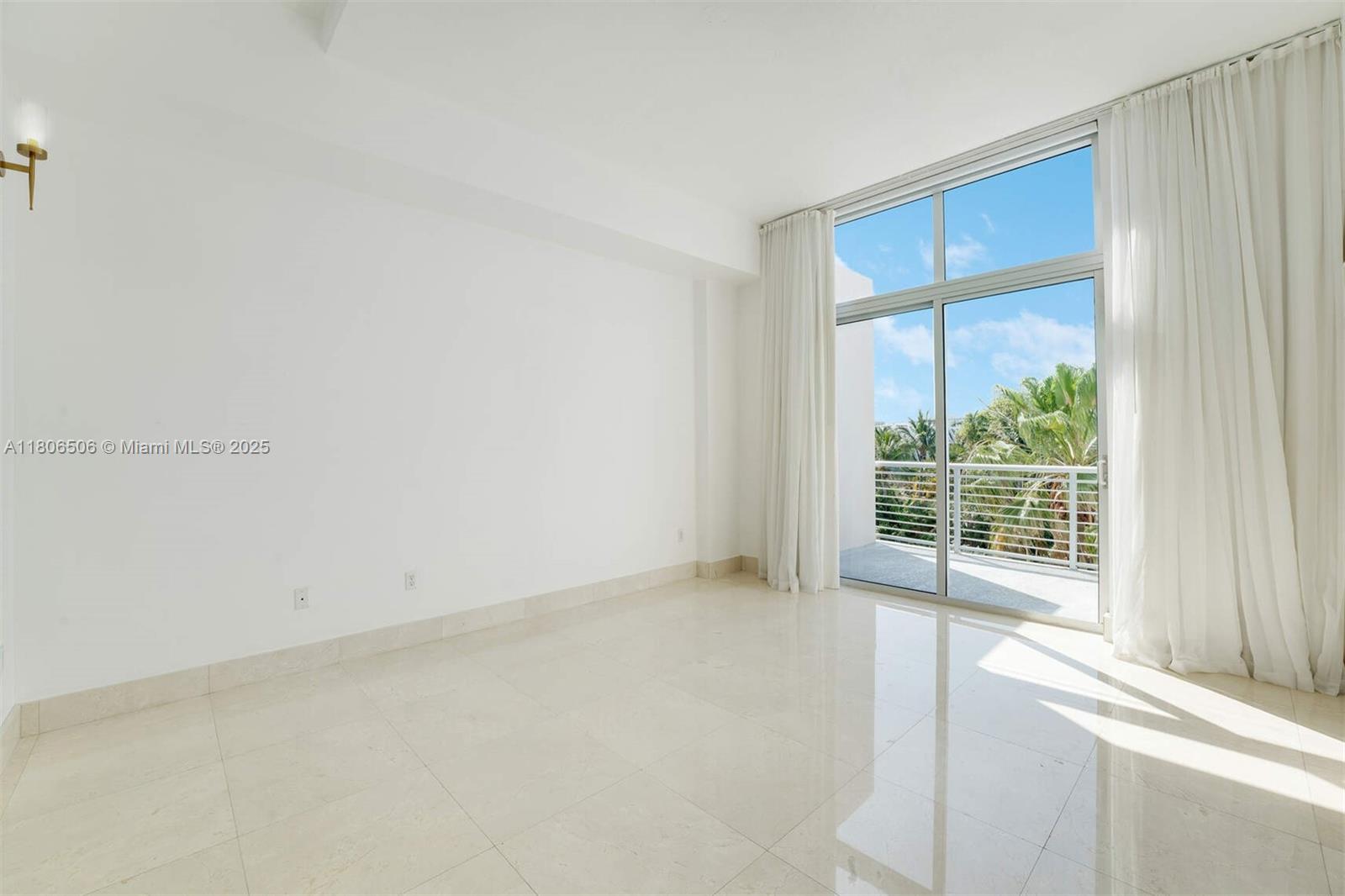 2001 Meridian Avenue, Unit 516 Miami Beach, FL 33139 - Photo 8 of 26 an empty room with windows