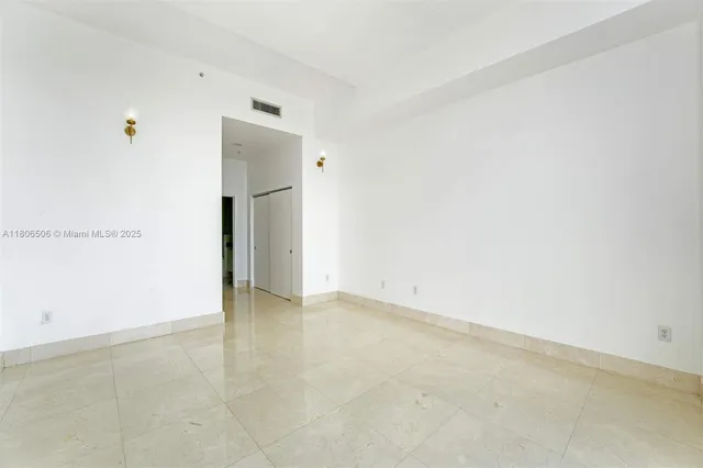 an empty room with a bathroom and a sink