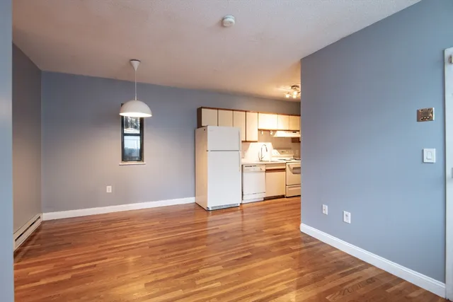 a view of a kitchen with a sink and wooden floor