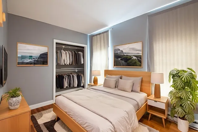 a bedroom with a bed and wooden floor