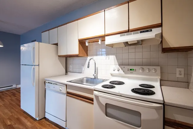 a kitchen with a refrigerator and a stove