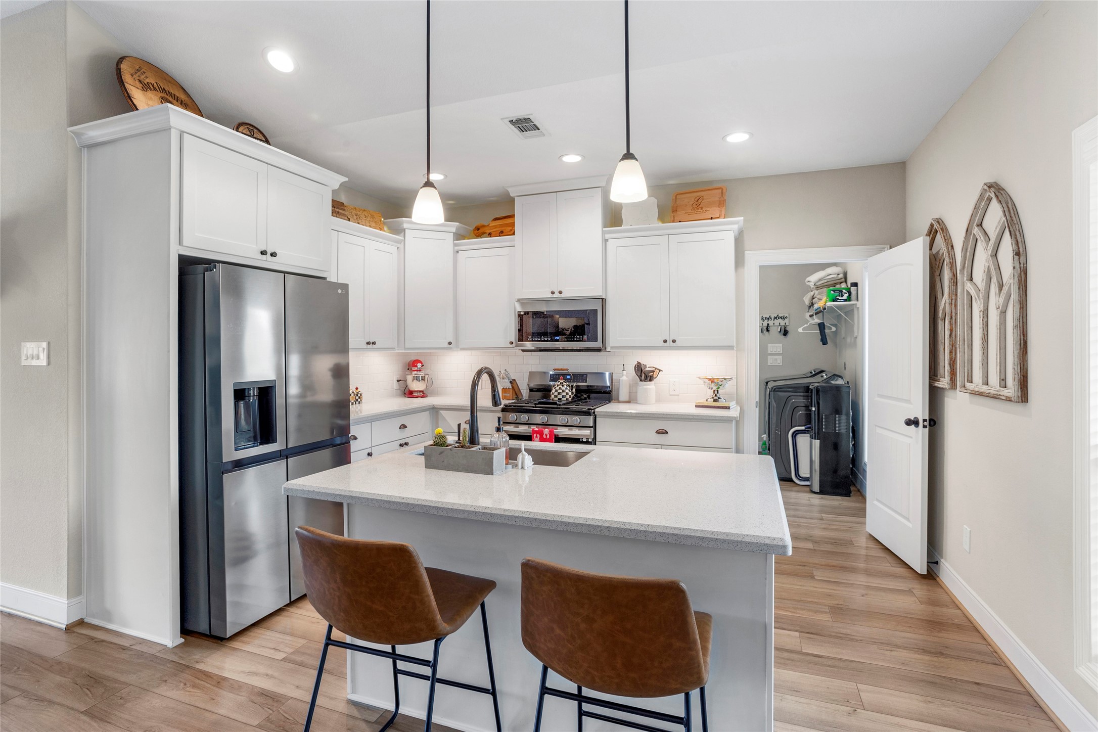 7634 Highland Road Santa Fe, TX 77517 - Photo 7 of 35 Kitchen with quartz countertops and an island with a farmhouse sink