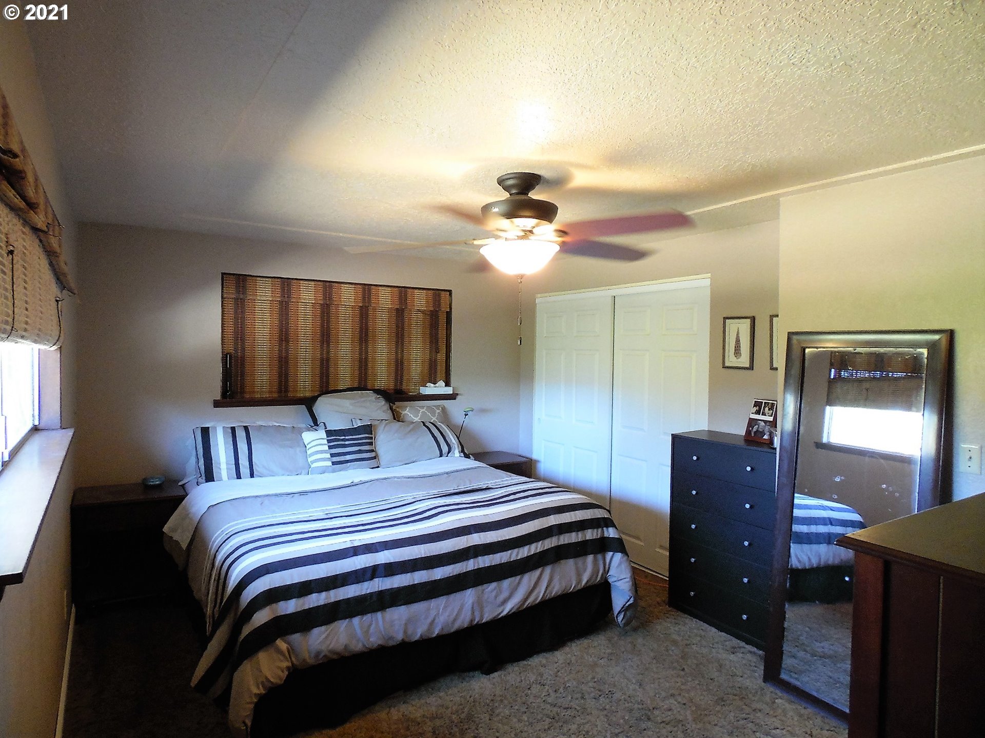 4235 Shoestring Road Riddle, OR 97469 - Photo 12 of 30 a bedroom with a bed and a chandelier