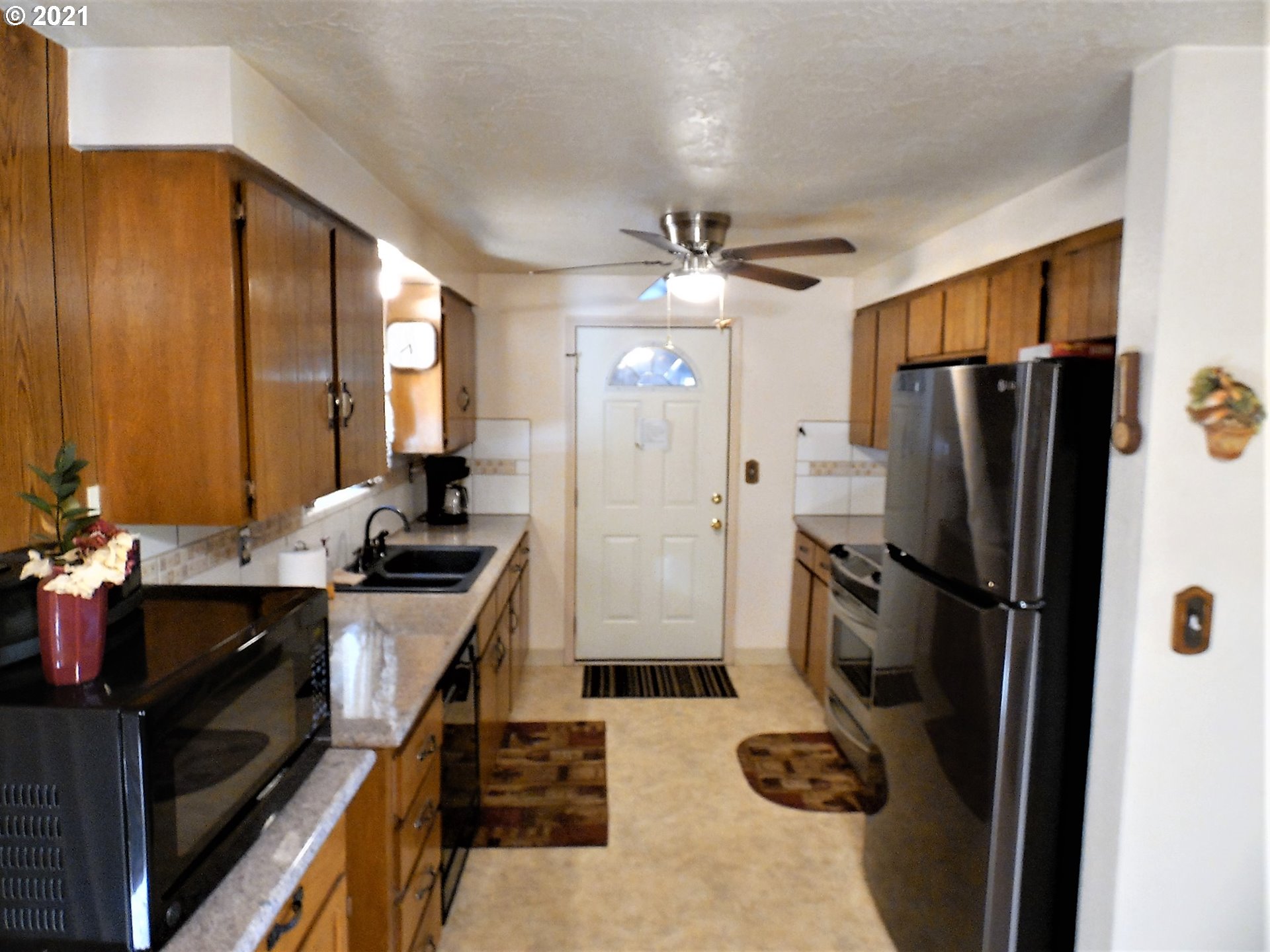4235 Shoestring Road Riddle, OR 97469 - Photo 9 of 30 a kitchen with a refrigerator a stove and a sink