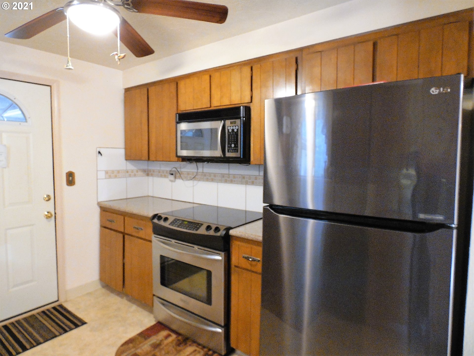 4235 Shoestring Road Riddle, OR 97469 - Photo 10 of 30 a kitchen with stainless steel appliances granite countertop a refrigerator and a stove top oven