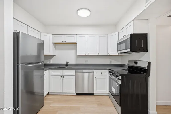 a kitchen with a sink stove and refrigerator