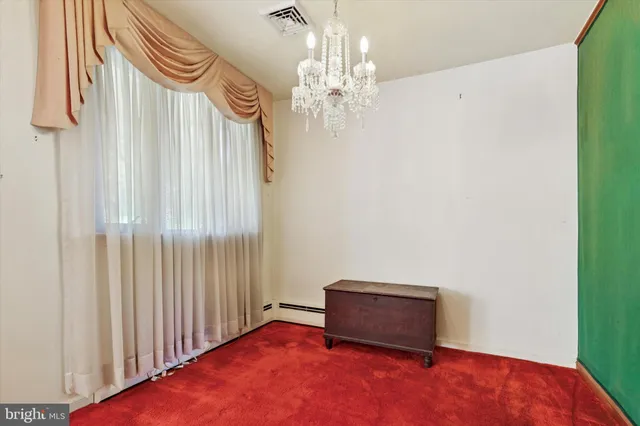 a room with a bed and a chandelier