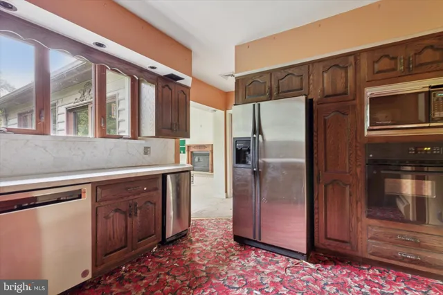 a kitchen with stainless steel appliances granite countertop a refrigerator and a sink