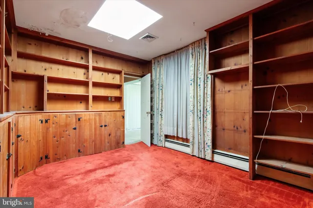 a view of an empty room with wooden walls