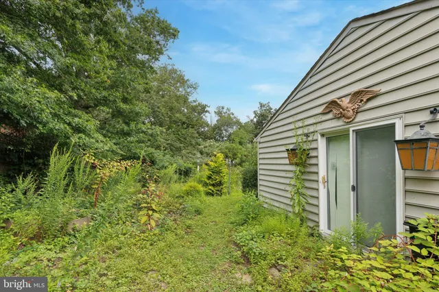 a view of a house with a yard and sitting area