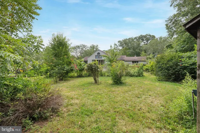 a yellow building with trees in the background