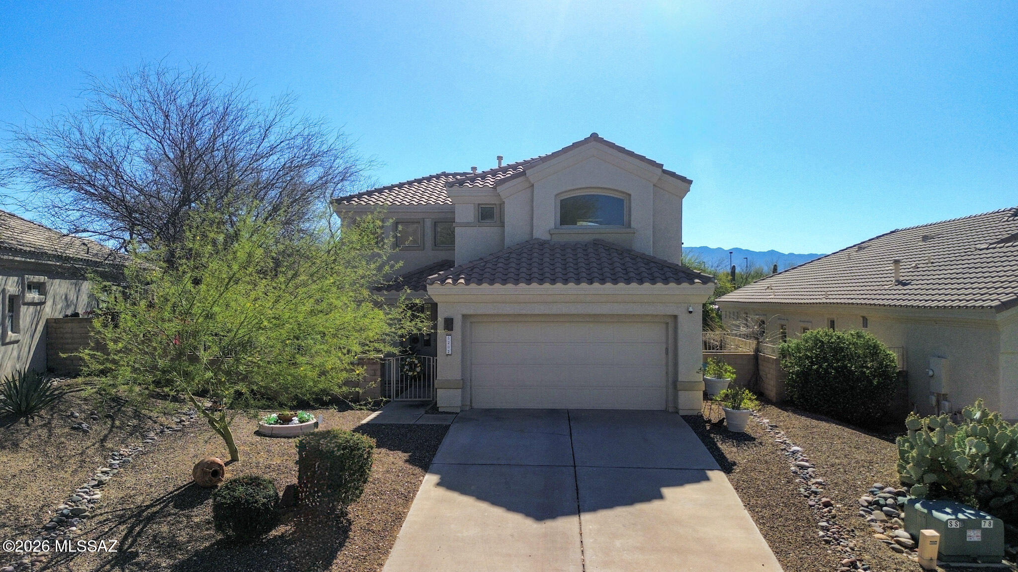 5202 Spring View Drive Tucson, AZ 85749 - Photo 4 of 49 a front view of a house with a yard